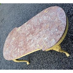 a marble top coffee table sitting on the ground