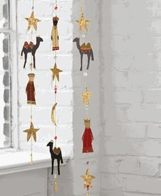 a white brick wall with christmas decorations hanging from it's sides and stars in the air