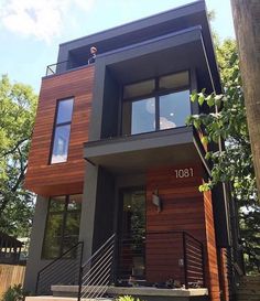 the front cover of a modern house with stairs leading up to it's second story