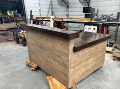 a wooden counter sitting inside of a garage