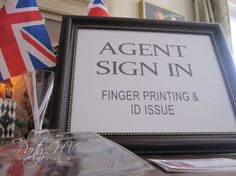 a sign that says agent sign in front of a flag and other items on a table