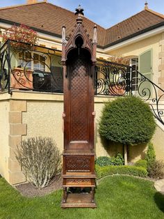 a tall wooden grandfather clock sitting in the grass