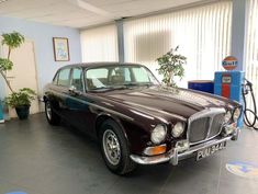 an old fashioned car is parked in a garage