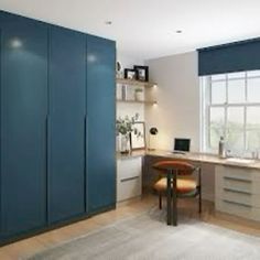 a kitchen with blue cabinets and white counter tops next to a large window in the corner