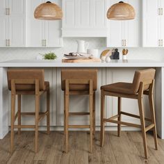 two wooden stools sitting in front of a kitchen island