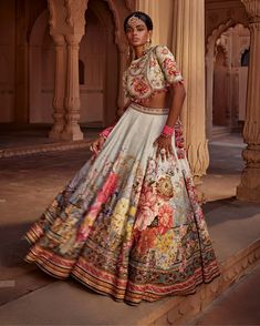 Featuring an elegant interplay of exquisite floral motifs with intricate hand embroidery on the lehenga. It is paired with a meticulously embroidered blouse with intricate thread and hand beadwork on yoke and sleeves and styled with a co-ordinated dupatta. Note: Potli is for styling purposes only Traditional Floral Print Choli For Reception, Traditional Designer Choli With Floral Print, Traditional Choli With Floral Print For Designer Wear, Bohemian Floral Print Choli For Wedding, Floor-length Floral Embroidery Set For Festivals, Floral Print Sets For Reception And Festivals, Floral Print Traditional Wear For Diwali Reception, Floor-length Art Silk Anarkali Set With Floral Embroidery, Traditional Floral Print Lehenga