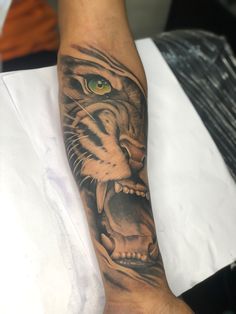 a man with a tiger tattoo on his arm