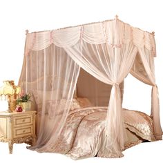 the canopy bed is made up with sheer curtains