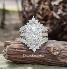 a diamond ring sitting on top of a piece of wood