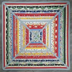 a colorful quilt is on the floor