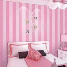 a bedroom with pink and white striped walls