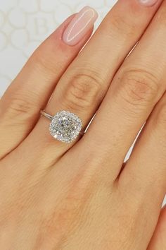 a woman's hand with a diamond ring on it