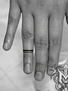 a person's hand with a ring on it and an arrow in the middle