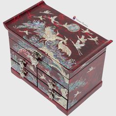 an elaborately painted wooden jewelry box with birds and flowers on the lid is shown