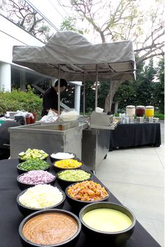 several bowls of food are sitting on a table