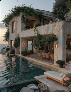 a house with a swimming pool in front of it and plants growing on the wall