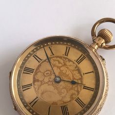 ANTIQUE Ladies 14k Gold Fob/Pocket Watch. c.1900. This is a beautiful time piece.  Beautiful floral engraved 14k gold case, having vacant shield cartouche to rear of case. Inner back hallmarked 14k gold. Guilded dial with floral engraving to centre. Black roman numeral chapter ring. Blue steel hands.  Mechinal Swiss movement. Bow wound. Watch dimensions - 31mm diameter. Height inc bow 47mm. This watch is sold with a 12 month guarantee from MBHI certificated watchmakers, established 1947. All watches will be serviced before shipping hence the 2-3 week dispatch. Please note - Watches are not waterproof unless otherwise stated and it is recommended not to wear them near water (i.e. washing hands, washing up, shower, swimming etc). Victorian Yellow Gold Pocket Watch With Chronometer, Victorian Gold Watch With Chronometer, Victorian Style Gold Watch With Chronometer, Victorian Yellow Gold Pocket Watch Collectible, Victorian Yellow Gold Pocket Watch For Collectors, Antique Yellow Gold Pocket Watch Collectible, Victorian Yellow Gold Pocket Watch For Formal Occasions, Victorian Self-winding Pocket Watch, Antique Yellow Gold Pocket Watch With Locket