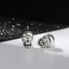 "We love the night. It's the only time I feel really alive." A striking set of earrings crafted in brilliant sterling silver inlaid with clear white stones. So cool, so unique. A unique statement piece that is great for everyday casual wear. It is also suitable to wear for Halloween to highlight your personality.Carat Weight: 0.1 ctStone Size: 1.8 mmStone Type: Jeulia® StoneNumber of Stones: 4 Stone Shape: RoundStone Color: Fancy BlackWeight: 3.43 gWidth: 7.3 mmHeight: 10.8 mmThickness: 5.2 mmMa Silver Skull Earrings For Pierced Ears, Silver Earrings With Diamond Eyes For Anniversary, Silver Skull Earrings, White Sterling Silver Skull Jewelry, White Skull-shaped Sterling Silver Jewelry, Sterling Silver Skull Earrings For Gift, Skeleton Knight, White Stones, Sterling Silver Stud Earrings