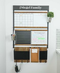 a magnetic board mounted to the side of a wall next to a potted plant