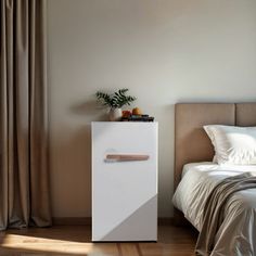 a bedroom with a bed, nightstand and curtained window in it's corner