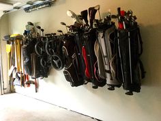 several golf clubs are hanging on the wall