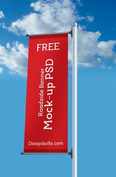 a red sign that is on the side of a pole with clouds in the background