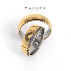 two wedding rings with blue sapphires on them, one in yellow gold and the other in white gold