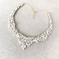 This Swarovski Rhinestone Statement Wedding Necklace features a combination of genuine Swarovski pearls and rhinestones with a high impact sparkle that will surely wow! Each stone is hand placed onto the design for a truly one of a kind, handmade statement bridal necklace. The details in this piece are beyond gorgeous. Choose silver or gold, and Ivory/Cream Pearls or White pearls at checkout to make this piece your own! You can even choose any of our 12 rhinestone colors ( or pick two! ) to trul Collar Necklace Gold, Necklace For Neckline, Wreath Necklace, Rose Gold Square, Gold Bridal Necklace, Chesapeake Va, Necklace Opal, Necklace Collar, Couture Bridal