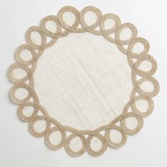 a round doily made out of jute and burlap with circles in the center