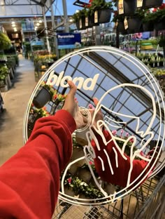 a person in a red jacket is pushing a shopping cart