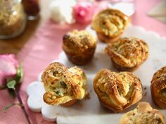 small pastries on a white plate with pink table cloth and flowers in the background