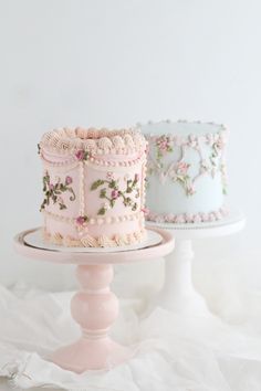 two cakes sitting on top of a white cake stand next to each other in different colors