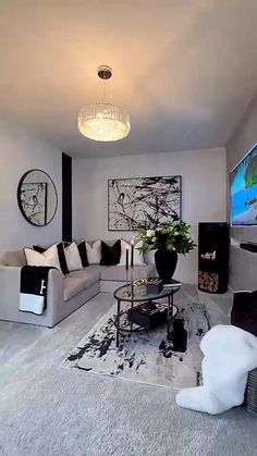 a living room filled with furniture and a flat screen tv mounted to the side of a wall