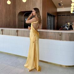 Jessica Gold Silk Maxi Dress - Shop Now - Aunomay Gold Dress Silk, Elegant Yellow Dress For Date Night, Yellow Satin Gown For Party, Yellow Satin Party Gown, Elegant Yellow Backless Dress, Elegant Yellow Satin Gown, Elegant Yellow Maxi Dress For Prom Season, Chic Fitted Gold Gown, Elegant Yellow Dress For Party Season