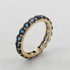 **KINDLY CHECK OUT THE VIDEO OF THE ITEM FOR A CLEARER VIEW**Details of the Ring: Gemstone: London Blue Topaz Gem shape,size & weight: Round, 3 mm ( 19 pc ) & 2.78 carats Metal: GOLD Purity: 14 KT (58.33%) approx Weight: 1.70 Grams Total weight of the Ring: 2.26 grams Ring size us 6 Infinity Band Beautiful Emerald cut London Blue Topaz rich deep blue color ring set in 14kt Yellow Gold, a perfect gift for a woman. The Gold purity is absolutely guaranteed and it comes with an authentic 14 Elegant Oval Topaz Stackable Ring, Stackable Blue Topaz Round Rings, Stackable Round Blue Topaz Rings, Fine Jewelry Blue Topaz Stackable Rings, Elegant Blue Oval Stackable Rings, Fine Jewelry Stackable Blue Topaz Rings, Formal Stackable Blue Topaz Jewelry, Stackable Blue Topaz Ring, Modern Blue Gemstones For Anniversary