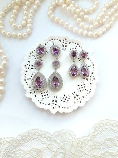 Simply elegant - big & beautiful amethyst crystal earrings with water drop pendant. There are two styles - smaller and more delicate delicate earrings - and longer earrings - rather statement earring without being too big. With classic design, beautiful purple and white stones shining in the light, they really are special. Perfect for a bride, bridesmaid or any special occasion to add some diamond glamour. Elegant Purple Dangle Chandelier Earrings, Elegant Purple Earrings For Pierced Ears, Crystal Long Drop Chandelier Earrings, Long Drop Crystal Chandelier Earrings, Elegant Purple Drop Earrings, Elegant Amethyst Earrings For Party, Cubic Zirconia Long Drop Chandelier Earrings For Gifts, Elegant Purple Drop Crystal Earrings, Elegant Purple Gemstone Chandelier Earrings