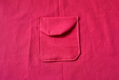 a pink cloth with a pocket on it