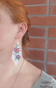 These handmade unique earrings with abstract floral print are made of high-quality Czech beads and strong synthetic thread. I use my author's scheme . They are elegant, fashionable, and highly versatile, suitable for everyday wear. Color: white,pink,purple,red,orange, green . 100% hand made with love! I beg you not to copy my authoring Copy without my permission is prohibited For those who want to buy my copyright scheme for these earrings: https://www.etsy.com/uk/listing/974991392/brick-stitch- White Single Flower Drop Earrings, White Single Dangle Flower Earring, White Flower Dangle Earrings, White Dangle Beaded Earrings, Handmade White Beaded Earrings For Gift, White Earrings As Summer Gift, Handmade Flower Chandelier Earrings Gift, White Flower Drop Earrings For Summer, White Summer Earrings For Gifts