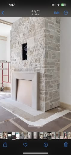 an image of a fireplace being installed in the living room with pictures on the wall