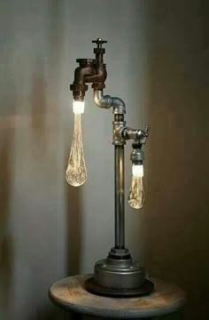 a lamp that is on top of a wooden stand with two light bulbs attached to it