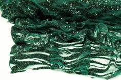 Emerald green beads and sequins on an emerald green tulle. Elegant Green Sequin Fabric, Glamorous Green Sequin Fabric, Glamorous Fitted Green Sequin Fabric, Green Sequin Fabric For Festive Party, Green Sequin Fabric For Party And Festive Occasions, Elegant Green Sequin Fabric For Festive Occasions, Embellished Green Glamorous Sequin Fabric, Embellished Green Sequin Fabric, Glamorous Green Embellished Sequin Fabric