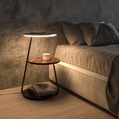 a table with a cup on it next to a bed