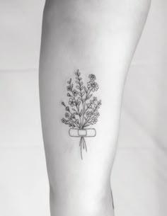 a woman's leg with a flower tattoo on it