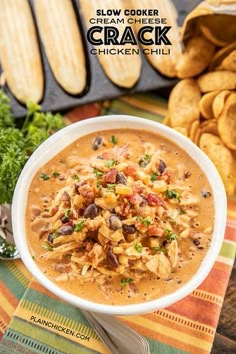 a bowl of slow cooker cream cheese chicken chili with tortilla chips on the side