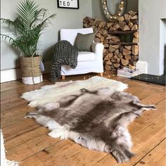 a living room filled with furniture and a pile of wood on top of a hard wood floor