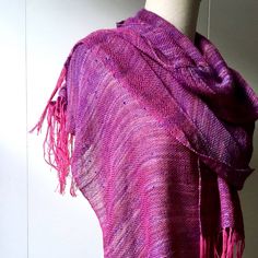 a purple shawl draped over a mannequin's head