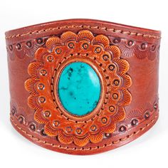 Western style hand-tooled vegetable tanned cowhide leather cuff bracelet is hand made by American Darling.A unique design pattern that catches the eye with its undeniable charm.The handmade leather bracelet is a go-to for your western look with any outfit you choose to slay in.2 snap button closure options to fit your wrist accordingly. Rustic Turquoise Leather Bracelet, Turquoise Bohemian Leather Bracelet, Bohemian Turquoise Leather Bracelet, Southwestern Leather Bracelet For Festival, Brown Bohemian Leather Bracelet With Concho, Leather Concho Cuff Bracelet, Southwestern Adjustable Leather Cuff Bracelet, Adjustable Southwestern Leather Cuff Bracelet, Hand Tooled Adjustable Leather Bracelets