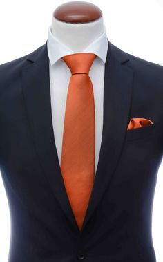 an orange tie and white shirt on a mannequin