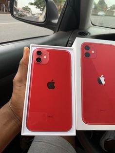 two red iphones are sitting in the car, one is open and the other is empty