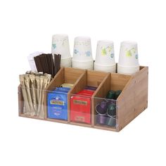 a wooden holder with cups and other items in it for pens, pencils, paper towels